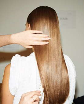 Model with sleek, blonde hair styled by Redken Global Creative Director, Guido Palau